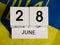 Wooden calendar and flag of Ukraine close-up. Constitution Day of Ukraine.