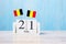 Wooden calendar of July 21th with miniature Belgium flags. Belgian National Day and happy celebration concepts