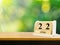 Wooden calendar on wooden desk show the date of April 22