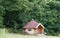 Wooden camping cabin in green field