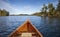 Wooden canoe on a blue Boundary Waters lake with islands on an autumn morning