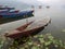 Wooden canoe boat of nepali people damage broken sunken ship in Phewa Tal or Fewa Freshwater Lake wait Nepalese wood carpenter or