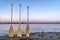 Wooden canoe paddles on a lake shore