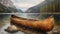 a wooden canoe resting on its side, nestled against a serene lakeside backdrop, evoking a sense of adventure and