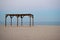 Wooden canopy awning gazebo by the sea beach sand morning