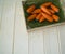 A wooden carrot is a toy.Children`s toy of orange color.