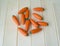 A wooden carrot is a toy.Children`s toy of orange color.