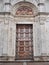 The wooden carved portal of an ancient cathedral in Italy