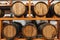 Wooden casks full of hard alcohol drinks stand on large rack