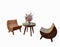 A wooden chair designed like a half moon. Set of chairs and tables decorated with flower vases