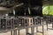 Wooden chairs stacked on tables. Local restaurant temporarily closed during lockdown COVID-19 or coronavirus outbreak pandemic.