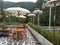 Wooden chairs table with umbrella in outdoor cafe