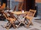 Wooden chairs and tables outside a street cafe