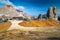 Wooden chalet and Cinque Torri rock formations in the Dolomites