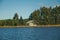 Wooden chalet facing a blue water lake