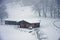 Wooden chalet on the Italian Alps during a heavy snowfall