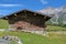 Wooden chalet and mountains with blue sky