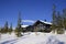 Wooden chalets among snow covered trees, Lapland