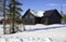 Wooden chalets among snow covered trees, Lapland