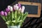 Wooden chalkboard copyspace Sign beautiful pink tulips bucket spring flowers tulip brown background