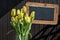 Wooden chalkboard copyspace Sign beautiful yellow tulips bucket spring flowers tulip brown background