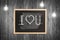 Wooden chalkboard with I love you note