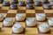 Wooden checkerboard with checkers spaced on table closeup