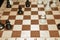 Wooden chess board with black pawns for leisure theme