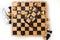 A wooden chess board and a phone. A view from above