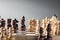 Wooden chess pieces on a chessboard, opposing pawns of different colors, the concept of strategy, planning and decision-making