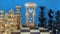 Wooden chess pieces on chessboard and sandglass