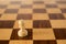 Wooden chess set, white pawn on board.