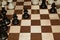 Wooden chessboard with black chessmen as a hobby concept