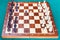 Wooden chessboard with first chess pawn moves