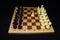 Wooden chessboard under black chessmen as a skill theme