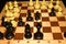 Wooden chessboard under black chessmen as a sport theme