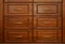 Wooden chest of with drawers with metal handles closeup