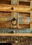 a wooden chest made of recycled old ship planks with rivets and metal rings