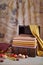 Wooden chest with stack of hand-dyed fabrics, autumn leaves, nuts and berries on an eco-print background