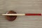 Wooden chopsticks, small brown bowl on background