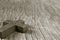 Wooden Christian cross on a rustic wooden surface, sepia toning