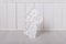 Wooden Christmas angel with small bulbs on white wooden blanks background. Xmas card. Concept of love of religion