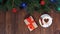 Wooden Christmas background with Christmas balls of different colors and a Christmas tree, a cup of coffee and a New