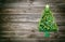 Wooden christmas background decorated with tree of green balls.