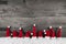 Wooden christmas background with red santa hats for a festive fr