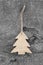 Wooden christmas carved tree - shabby style on a grey background