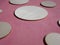 wooden circles of different diameters on pink suede