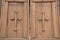 Wooden closed gates with crosses on the doors