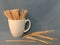 Wooden coffee stirrers in a coffee mug