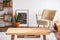 Wooden coffee table in elegant living room interior, real photo